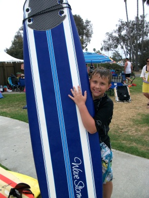 Will poses with his board after his lesson